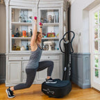 Woman exercising on a Power Plate machine in a home setting.