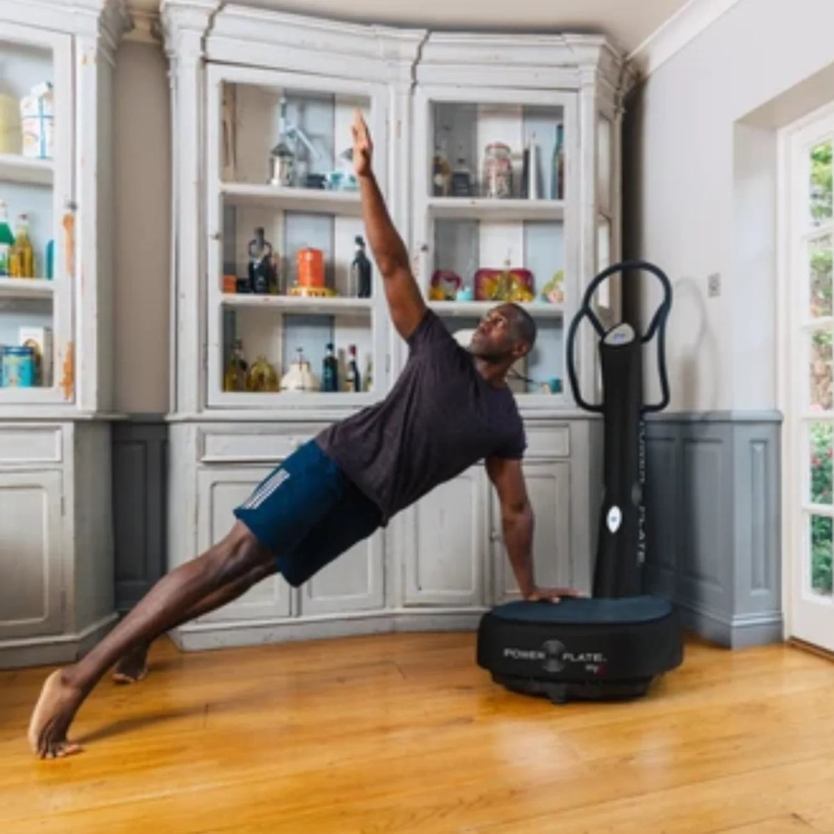 Person using a Power Plate in a home setting.